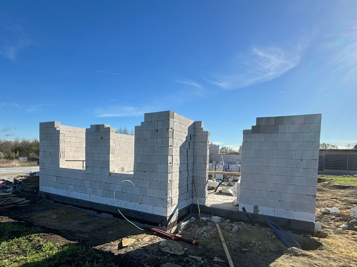 Stavební firma na staveništi rodinného domu, probíhá vyzdívka obvodových zdí